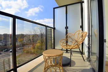 A balcony with a chair and table